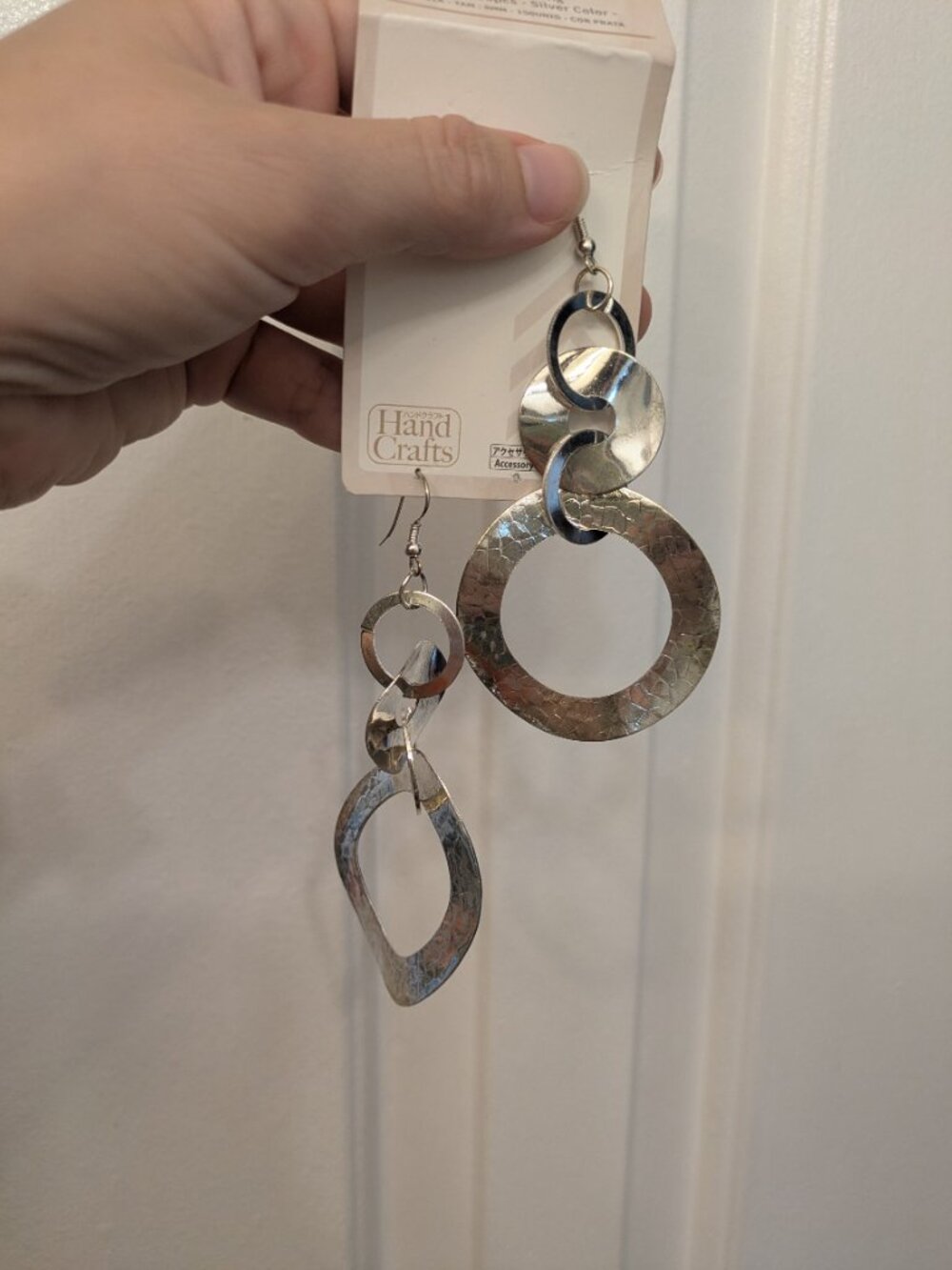 Long big silver metal earrings with multiple loops and texture